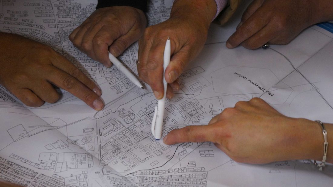 Community members examine maps to decide where Local Development Funds should be allocated. 