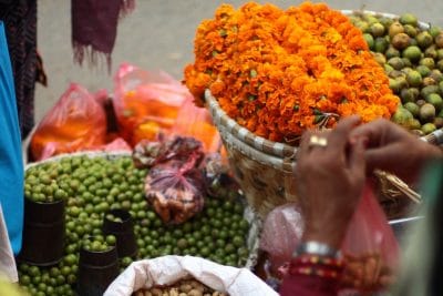 Orange flowers and dates on display at a marketplace in Nepal