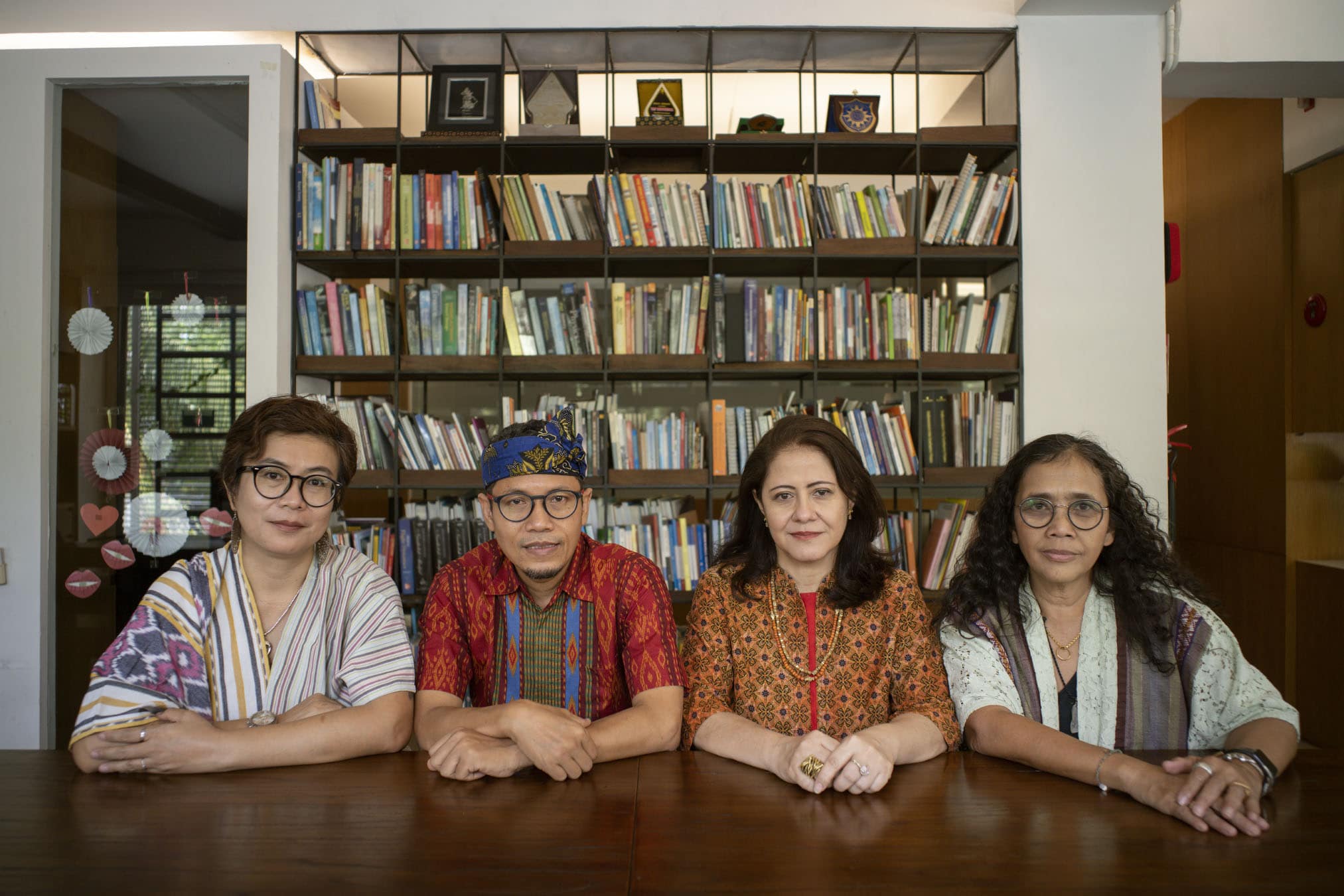 four people sit at a table