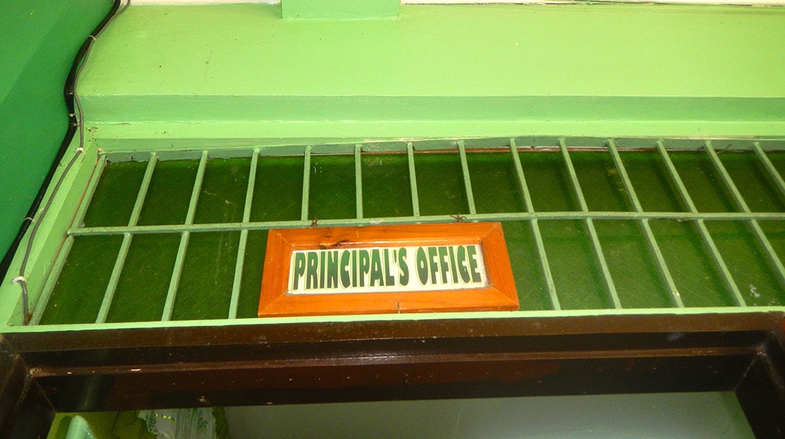 A sign hanging over a door entrance that reads "Principal's Office."