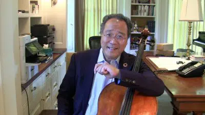Yo-Yo Ma sits with his cello in his office.