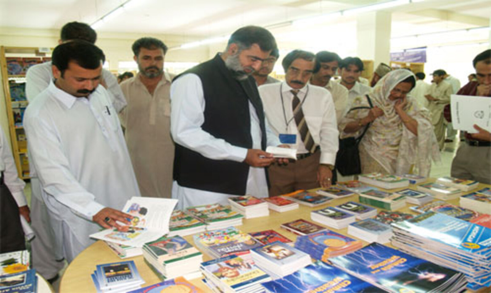 Representatives from different institutions select books at a Books for Asia Book Fair. 