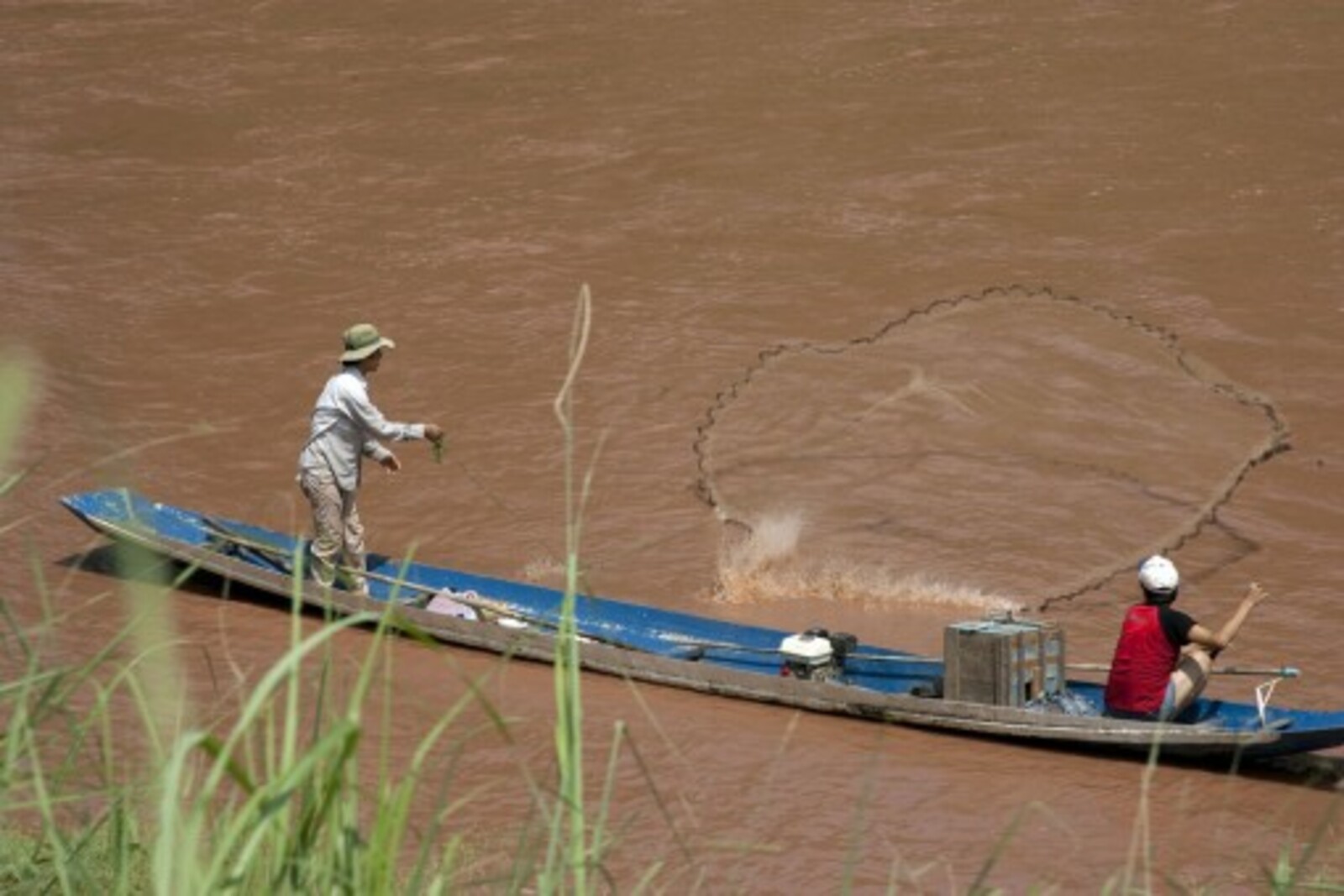 As the country the holds the largest percentage of the Mekong River, Laos relies heavily on the river's steady flow for food supply, such as fishing pictured above as well as electricity and transportation.