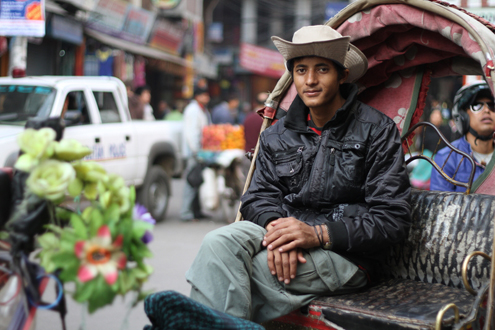 Man waits in his rickshaw for a customer.