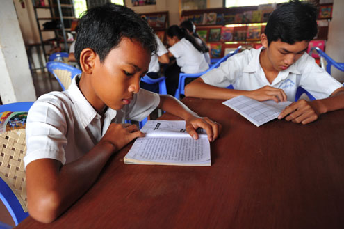 Cambodian students reading books. 
