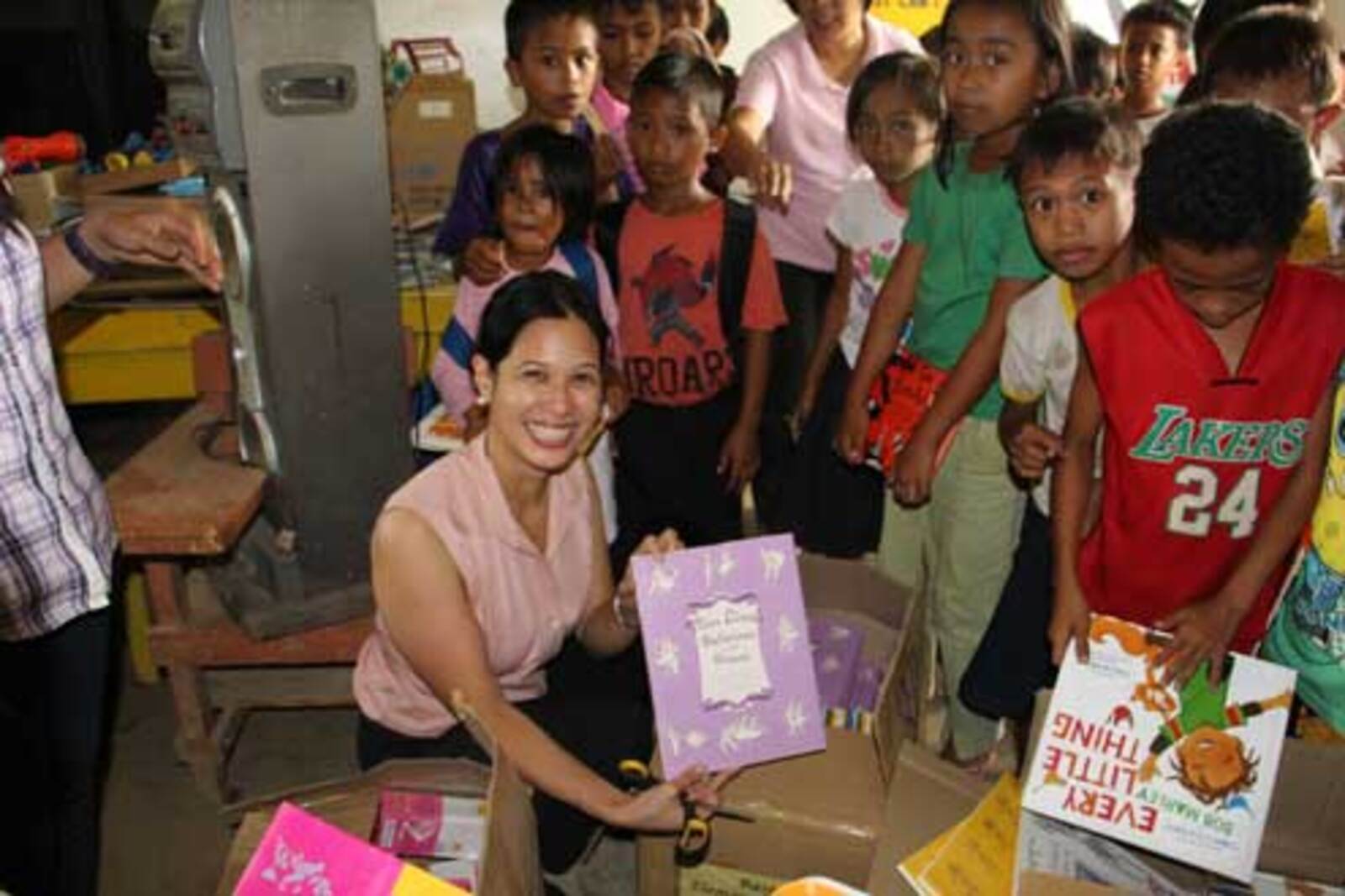 Anna Bantug-Herrera presents storybooks to Basper Elementary School students in Tacloban.  